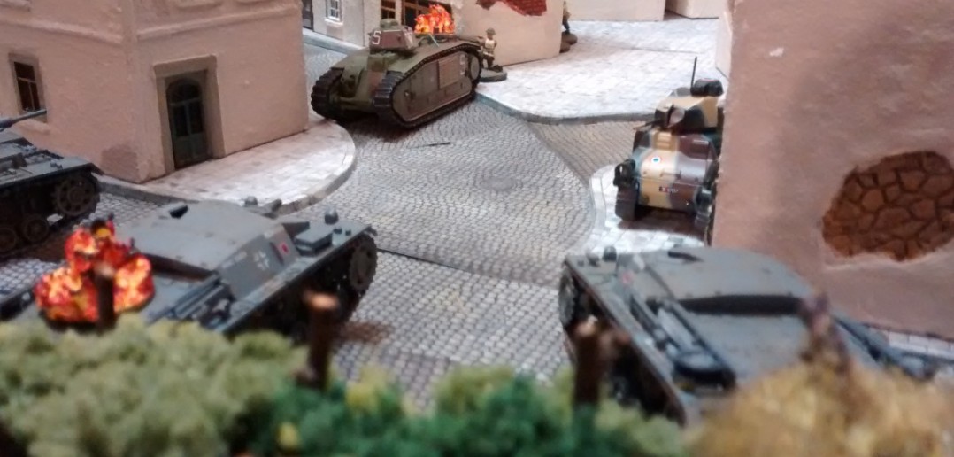 Auf der rechten deutschen Flanke dreht der Char b1 aus dem Widerstandsnest den Turm und unterhält sich mit dem Kübelwagen in der Straße...