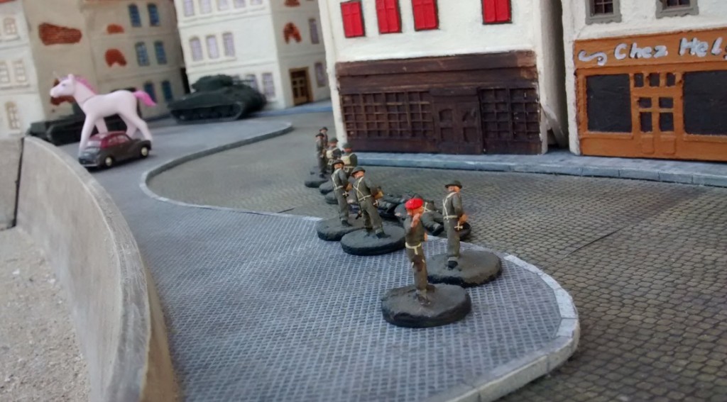 Sergeant MacCallahan schließt zu den beiden Tanks auf. Sherman und Cromwell bleiben zunächst vorsichtig in Deckung, bevor sie gleich weiter in die Altstadt von Saint-Aubin-Sur-Mer vordringen werden.