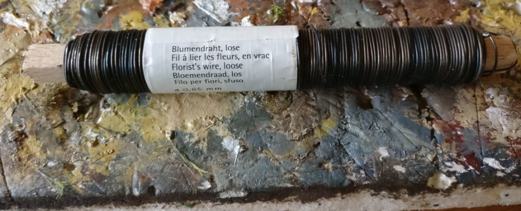 Blumendraht der einfachsten Sorte soll als elastisches Baumaterial für die Baumstämme dienen und das Islandmoos fest auf der Base halten.